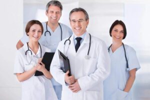Female and male doctors holding note pads and smiling