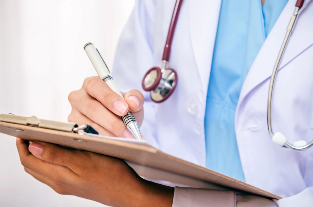 A doctor taking notes on a clipboard